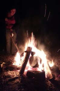 Getting ready to put a foil-wrapped banana on the coals.